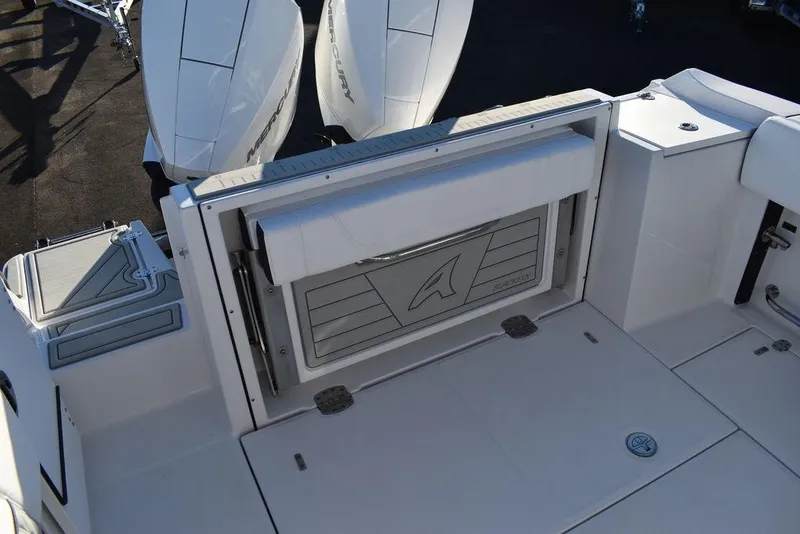 Slide: The Image of 2024 Blackfin 252DC boat deck with dual engines and storage compartment. - 14