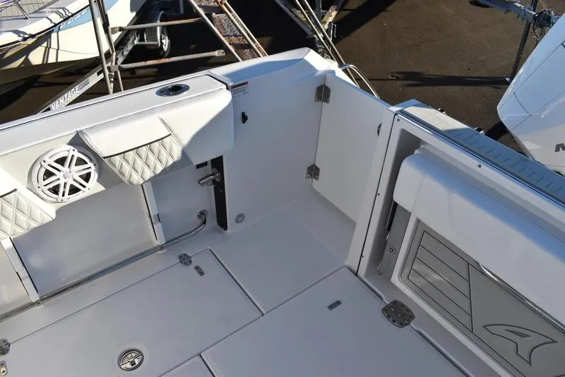 Slide: The Image of 2024 Blackfin 252DC boat interior with sleek white seating and storage compartments. - 18