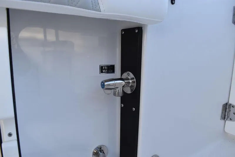 Slide: The Image of 2024 Blackfin 252DC boat detail showing a chrome fixture on a white surface. - 19