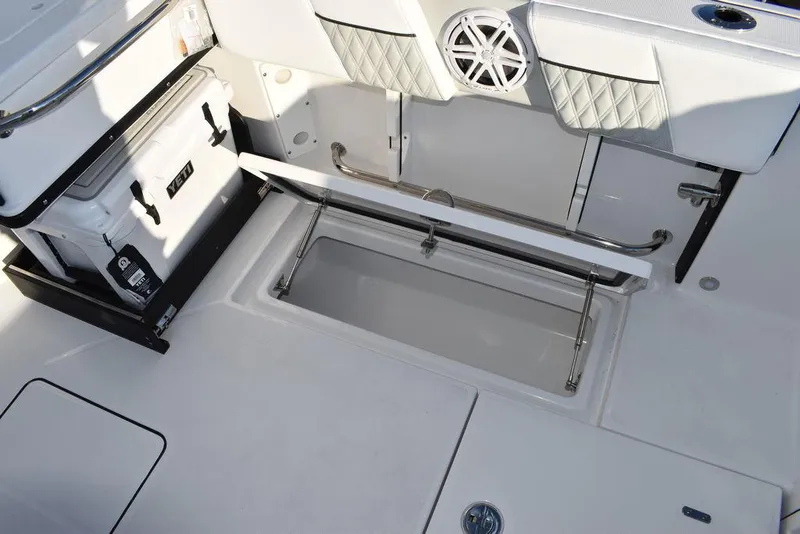 Slide: The Image of 2024 Blackfin 252DC boat interior with storage compartment and cooler. - 22