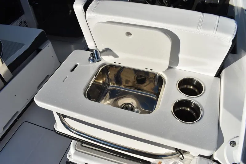 Slide: The Image of 2024 Blackfin 252DC boat sink and cup holders in white interior. - 24