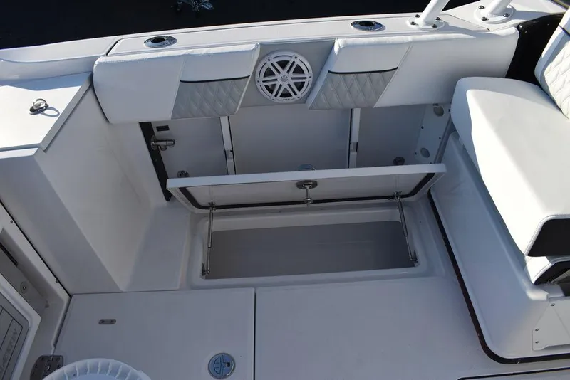 Slide: The Image of 2024 Blackfin 252DC boat interior with open storage compartment and seating. - 27