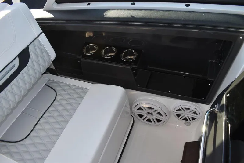 Slide: The Image of 2024 Blackfin 252DC boat interior with white seating and built-in speakers. - 32