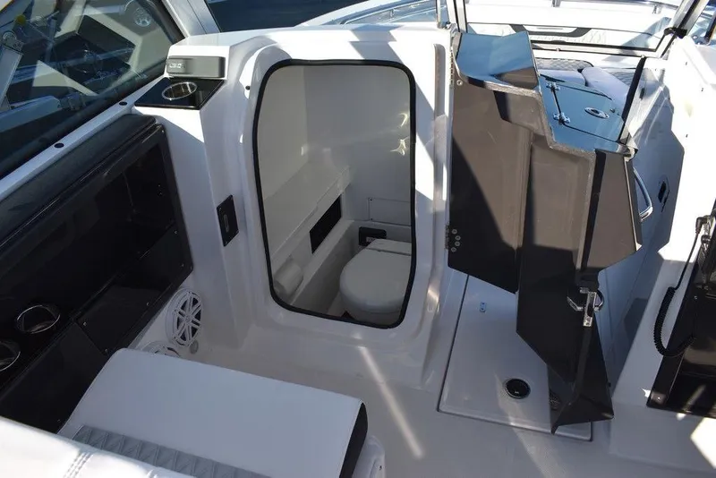 Slide: The Image of 2024 Blackfin 252DC boat interior with compact cabin and seating area. - 34