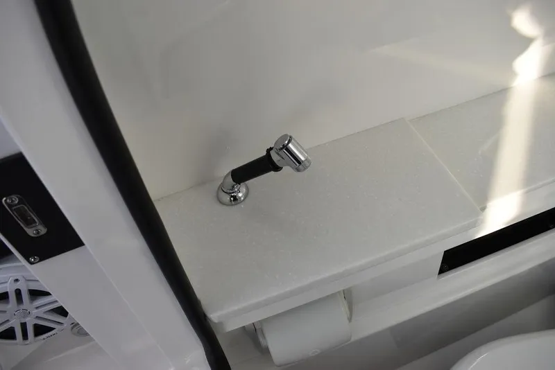 Slide: The Image of 2024 Blackfin 252DC interior detail with chrome faucet and white countertop. - 36