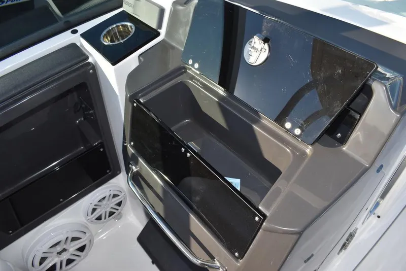 Slide: The Image of 2024 Blackfin 252DC boat interior with storage compartments and cup holder. - 39