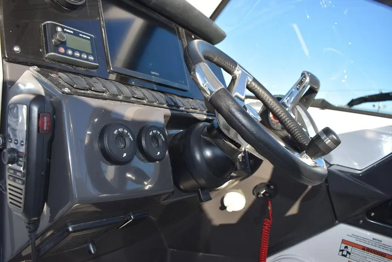 Slide: The Image of 2024 Blackfin 252DC boat dashboard with steering wheel and controls. - 49