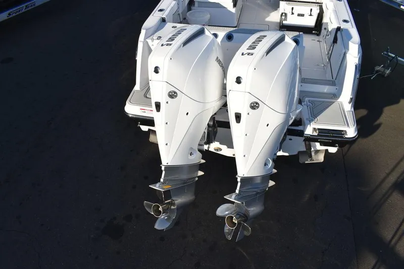 Slide: The Image of 2024 Blackfin 252DC boat with dual outboard engines, rear view. - 6