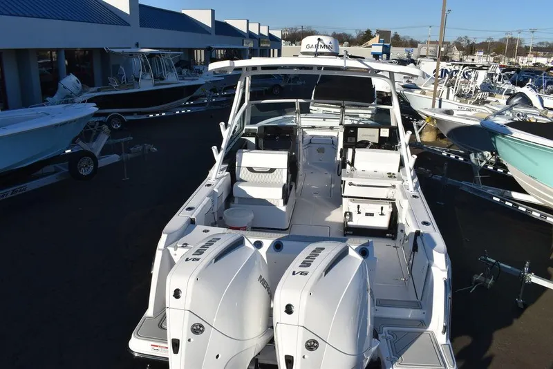 Slide: The Image of 2024 Blackfin 252DC boat with dual engines at a dealership. - 8