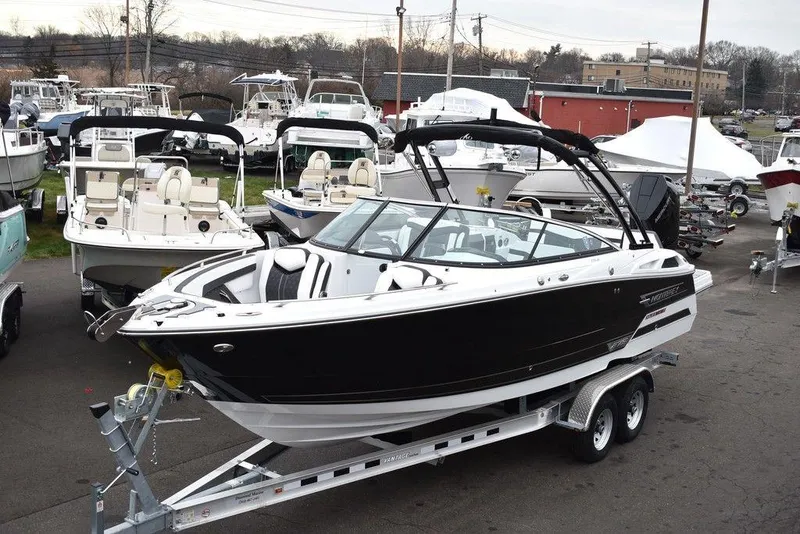 The Image of 2024 Monterey 275SS black boat on trailer at marina. - 1