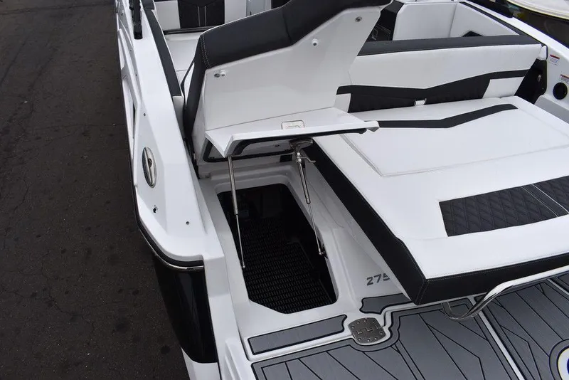 Slide: The Image of 2024 Monterey 275SS boat with open storage compartment and sleek seating. - 24
