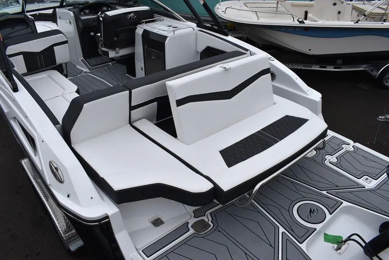 Slide: The Image of 2024 Monterey 275SS boat interior with white and black seating. - 25
