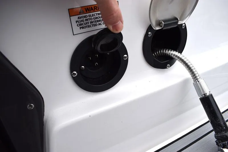 Slide: The Image of 2024 Monterey 275SS boat electrical and fuel ports with warning label. - 29