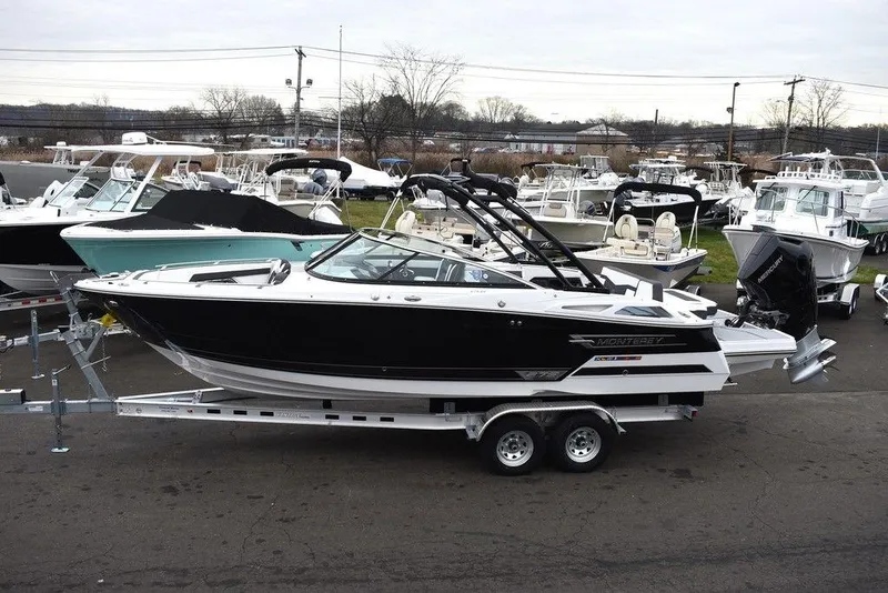 Slide: The Image of 2024 Monterey 275SS boat on a trailer in a marina. - 3