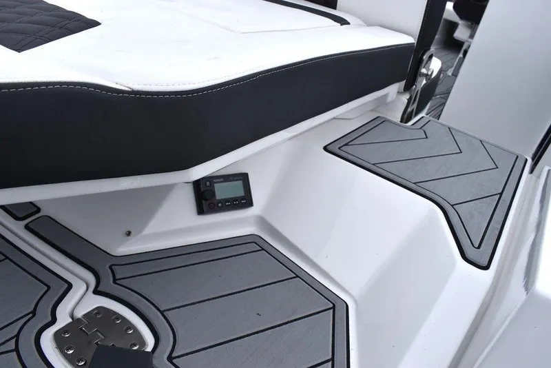 Slide: The Image of 2024 Monterey 275SS boat interior with black and white seating and gray flooring. - 30