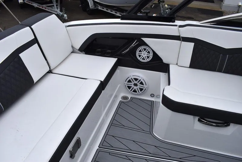 Slide: The Image of 2024 Monterey 275SS boat interior with white and black seating and built-in speakers. - 34