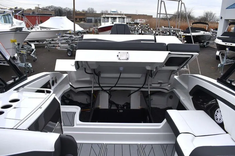 Slide: The Image of 2024 Monterey 275SS boat with open engine compartment in a marina. - 42