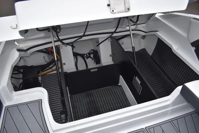 Slide: The Image of 2024 Monterey 275SS boat engine compartment with open hatch and visible wiring. - 44