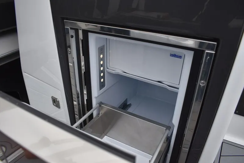 Slide: The Image of 2024 Monterey 275SS boat refrigerator with stainless steel interior. - 48