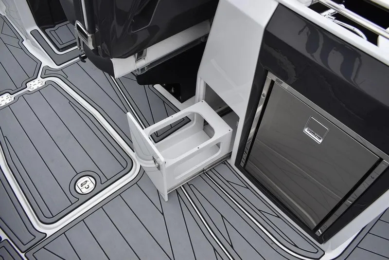 Slide: The Image of 2024 Monterey 275SS boat interior with gray flooring and built-in storage. - 49