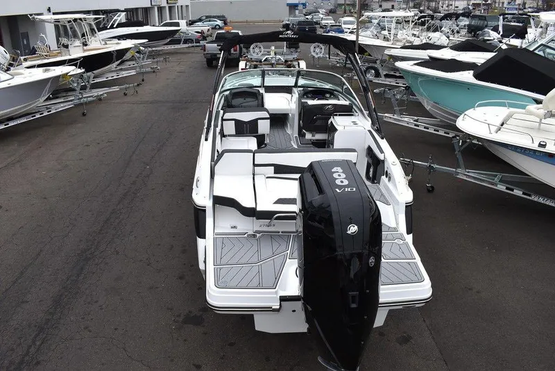 Slide: The Image of 2024 Monterey 275SS boat with powerful outboard engine, docked among other boats. - 6