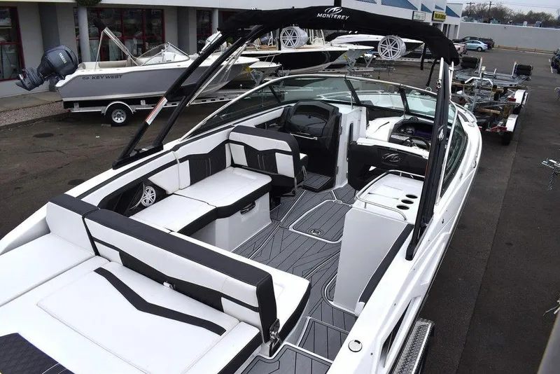 Slide: The Image of 2024 Monterey 275SS boat interior with black and white seating, modern dashboard, and spacious layout. - 9