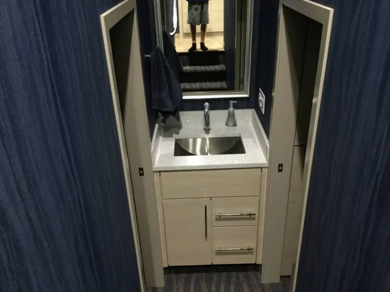 Slide: The Image of Modern bathroom with glass shower, wooden cabinets, and bright lighting, Adonia Azul Trip 2017. - 13