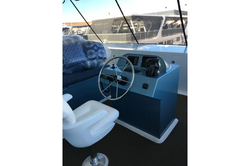 Slide: The Image of Boat helm with white captain's chair and blue console, Adonia Azul Trip 2017. - 30