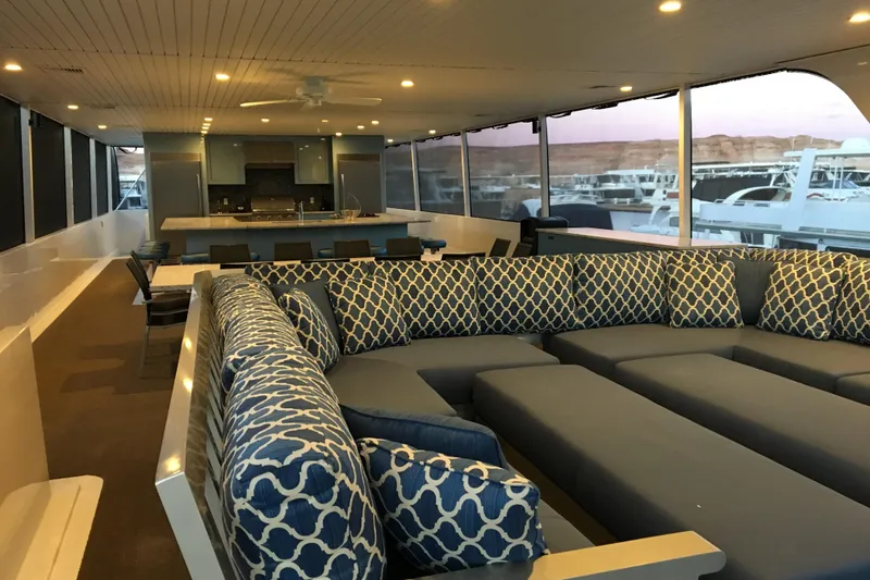 Slide: The Image of Luxurious yacht interior with patterned seating, dining area, and panoramic windows. Adonia Azul Trip 2017. - 38