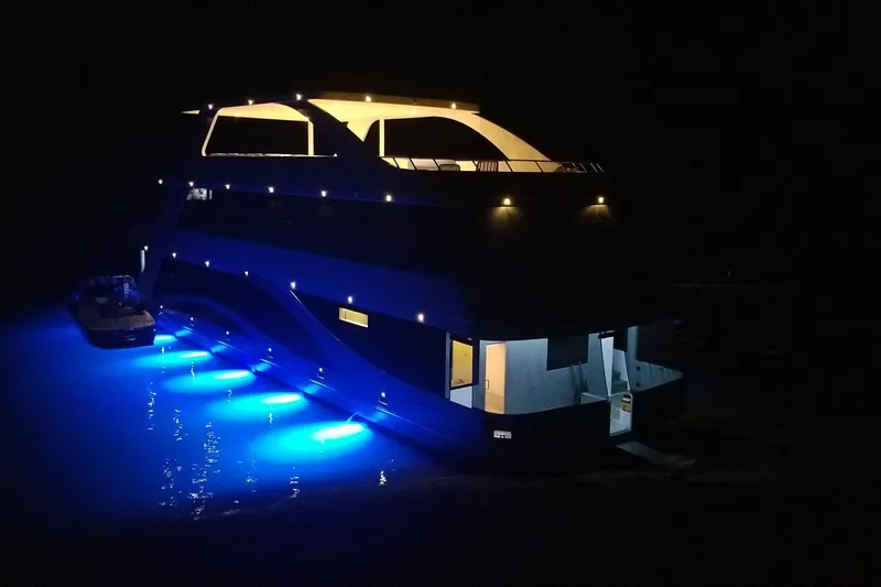 Slide: The Image of Luxurious yacht "Adonia Azul" illuminated at night with vibrant blue underwater lights. - 41
