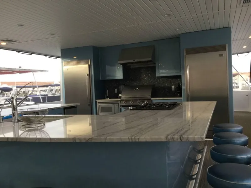 Slide: The Image of Luxurious yacht interior with modern kitchen, dining area, and large windows. Adonia Azul Trip 2017. - 7