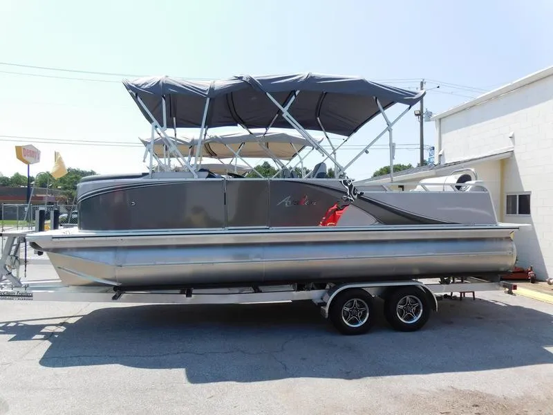 The Image of 2023 Avalon 2385 LSZ VRL pontoon boat on trailer, featuring a sleek design and canopy. - 0