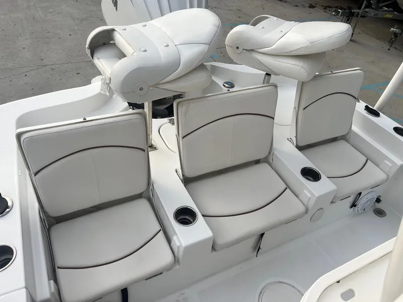 Slide: The Image of 2022 Sea Hunt BX 25 BR boat seating with white cushioned seats and cup holders. - 7