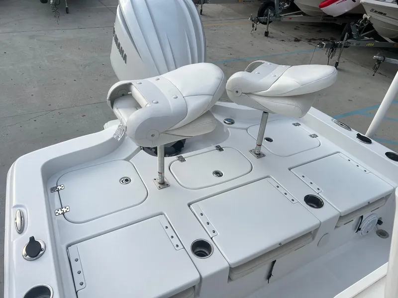 Slide: The Image of 2022 Sea Hunt BX 25 BR boat with dual white seats and storage compartments. - 8