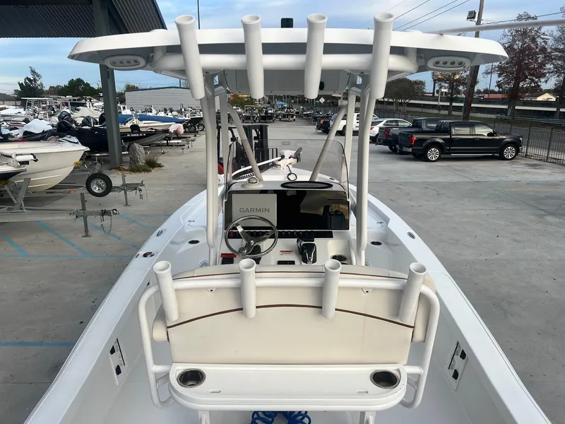 Slide: The Image of 2022 Sea Hunt BX 25 BR boat with center console and rod holders in a marina. - 9