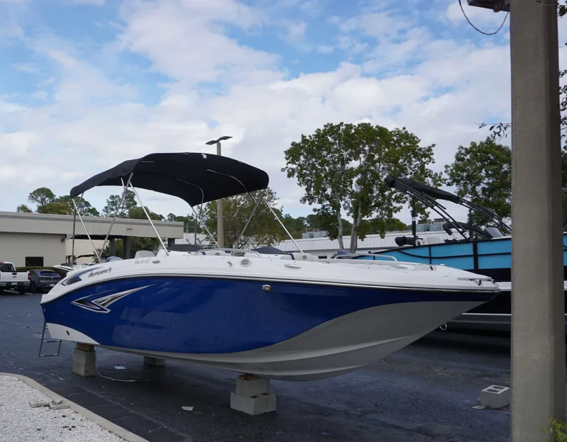 Slide: The Image of 2024 Hurricane 218 SS boat with blue hull and black canopy on display. - 1