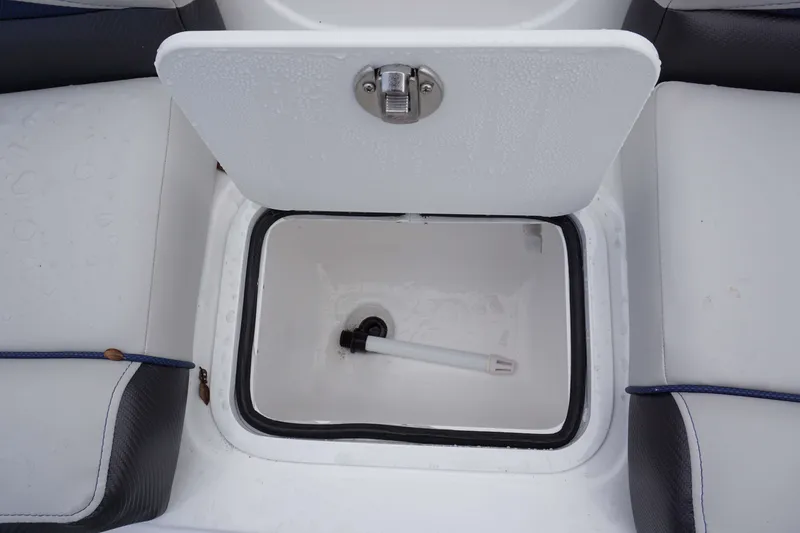 Slide: The Image of Open storage compartment on 2024 Hurricane 218 SS boat with water droplets. - 10
