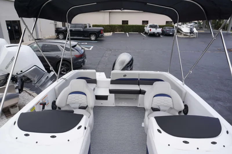 Slide: The Image of 2024 Hurricane 218 SS boat interior with seating and Mercury outboard motor. - 16