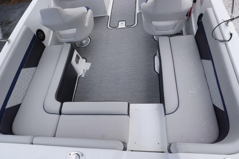 Slide: The Image of 2024 Hurricane 218 SS boat interior with grey and white seating and carpet. - 19