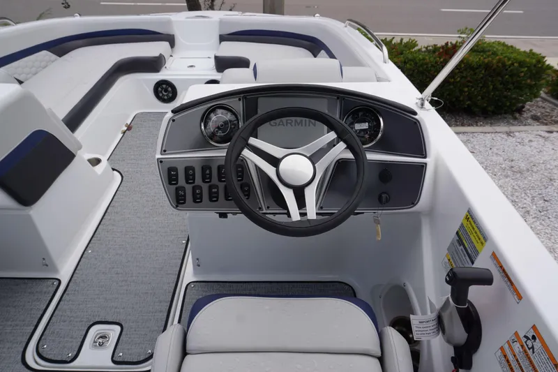 Slide: The Image of 2024 Hurricane 218 SS boat dashboard with Garmin navigation system and steering wheel. - 3