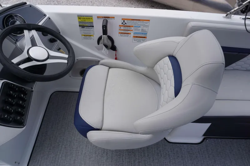 Slide: The Image of 2024 Hurricane 218 SS boat cockpit with steering wheel and cushioned captain's chair. - 4