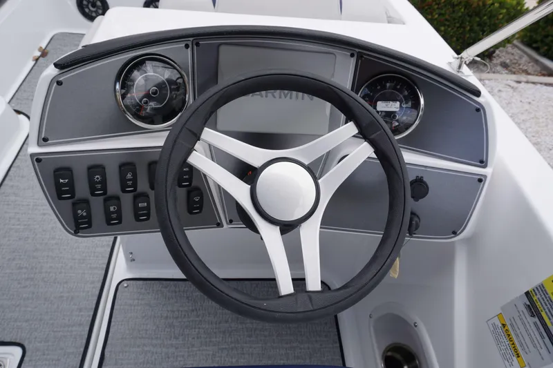 Slide: The Image of 2024 Hurricane 218 SS boat dashboard with steering wheel and control panel. - 5
