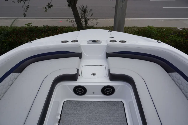 Slide: The Image of 2024 Hurricane 218 SS boat interior with cushioned seating and cup holders. - 9