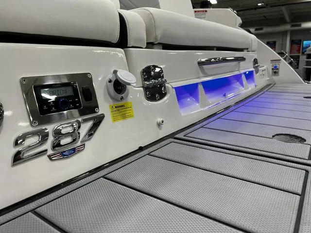 Slide: The Image of 2024 Chaparral 287 SSX boat interior with illuminated seating and control panel. - 12