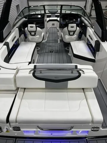 Slide: The Image of 2024 Chaparral 287 SSX boat interior with white seating and modern dashboard. - 14