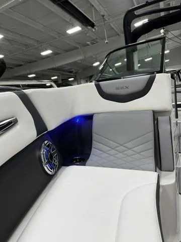 Slide: The Image of 2024 Chaparral 287 SSX boat interior with modern seating and blue LED lighting. - 19