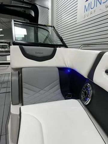 Slide: The Image of 2024 Chaparral 287 SSX boat interior with white and gray seating. - 20