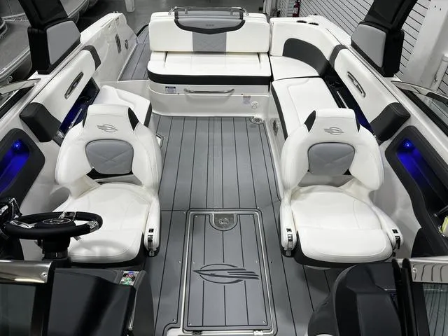 Slide: The Image of 2024 Chaparral 287 SSX boat interior with white and gray seating and modern design. - 21