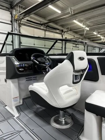 Slide: The Image of 2024 Chaparral 287 SSX boat interior with captain's chair and dashboard. - 22