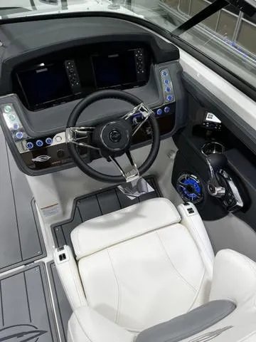 Slide: The Image of 2024 Chaparral 287 SSX boat cockpit with modern steering wheel and control panel. - 23